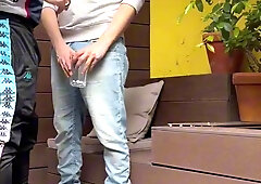two guys attempt to urinate in a glass (one gets firm )