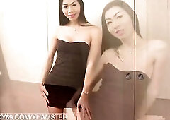 Slender Oriental tranny with large tits strokes her bald weenie