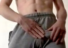 Twunk spanks manmeat around in grey sweatpants. LARGE cum-shot