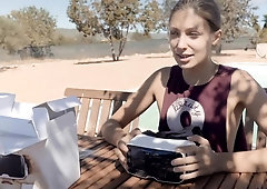 Provoking brunette teen plays with her shaved cunt outside