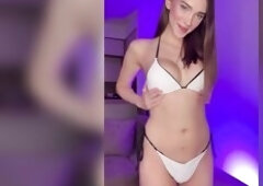 Large titties squeezed in white as this babe smiles at the camera ?