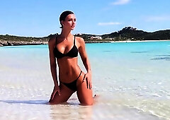 Stunning bikini babe poses for photoshoot on the beach