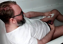 Chastity locked bear pisses his clothes and over himself