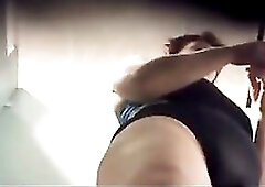 Older woman caught in pool cabin undressing her swimsuit and dressing her pants and raiment.