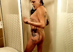 Mistress Cy seduces during car wash, then takes a steamy shower before dressing up in lingerie