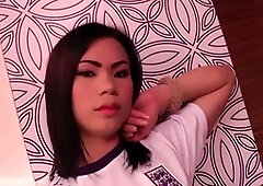 Slim ladyboy in red lipstick strips off football jersey