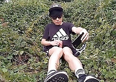 Jon Arteen, a gay Asian twink, is dressed in an Adidas t-shirt, hot pants, white socks, and Duramo