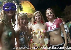 Blonde teens show off elaborate body paint at a Key West festival