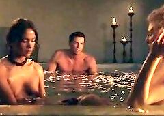 Viva Bianca topless in a bathroom with floating flower petals in it. Then Viva Bianca making out with a chap standing against a wall and lifting her l