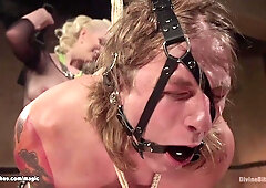 Man in invered suspension ass caned